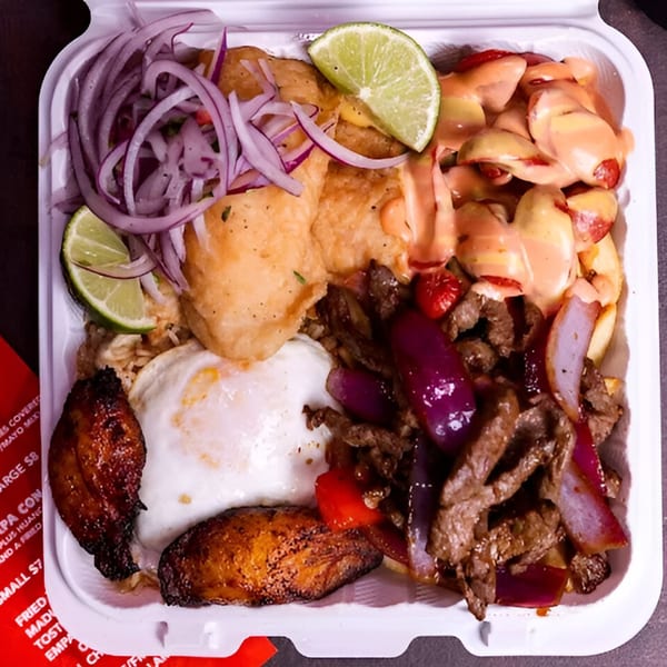 A Peruvian Lomo Saltado dish in a takeout container with beef, onions, fried egg, and plantains.