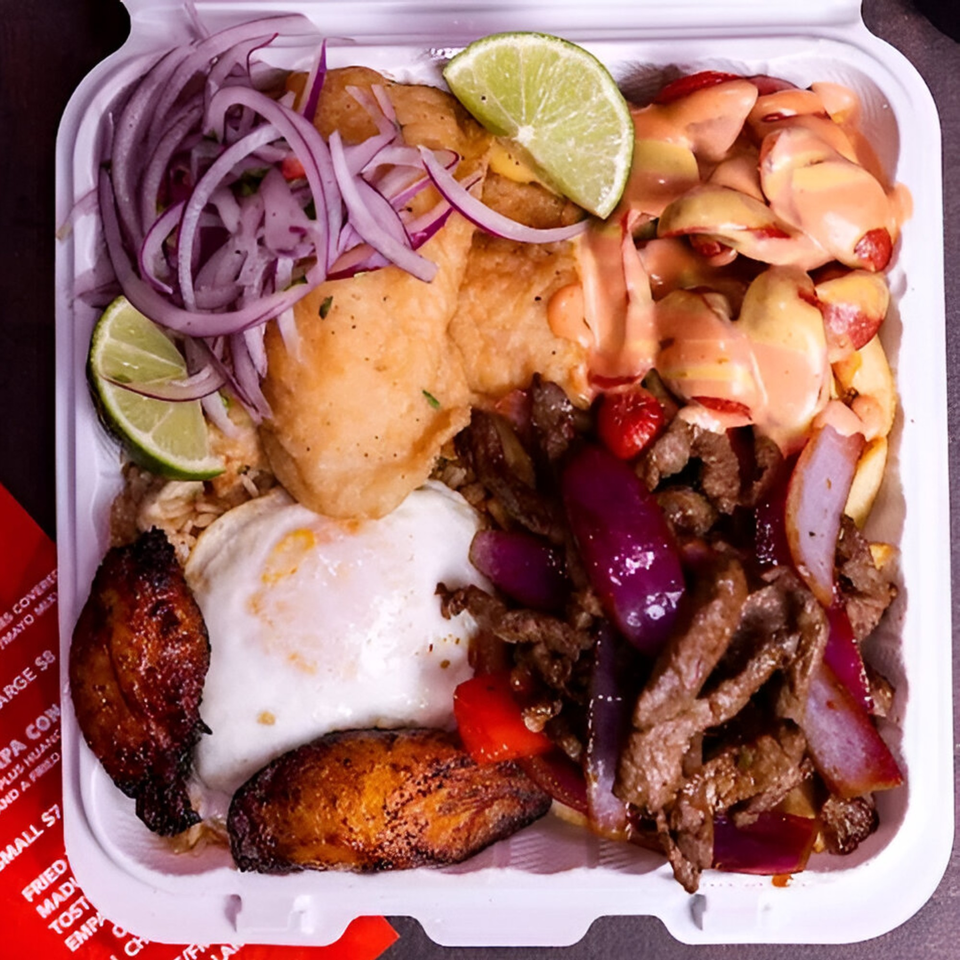 A Peruvian Lomo Saltado dish in a takeout container with beef, onions, fried egg, and plantains.
